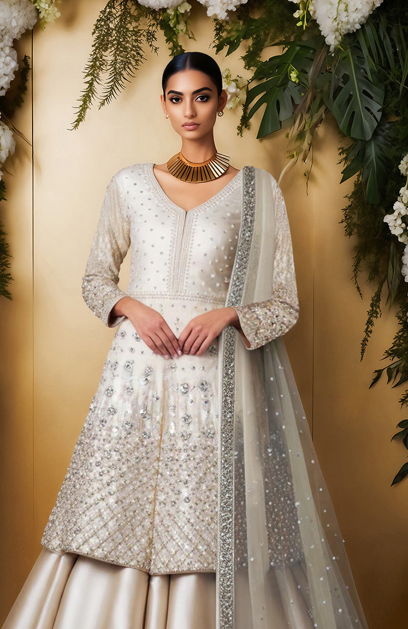 Ivory skirt set with bead and crystal embroidery, long jacket top, full sleeves, and sheer dupatta.