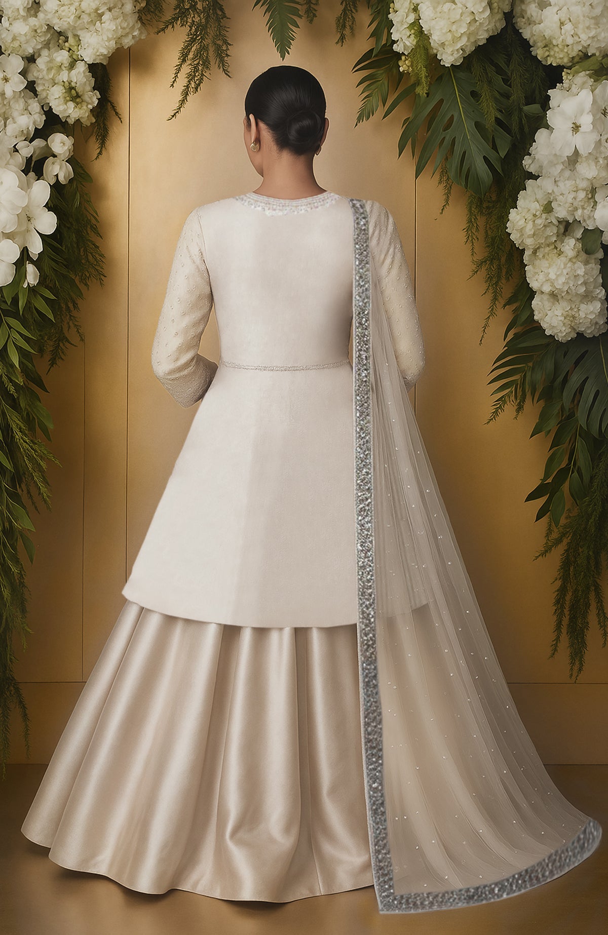 Ivory skirt set with bead and crystal embroidery, long jacket top, full sleeves, and sheer dupatta.
