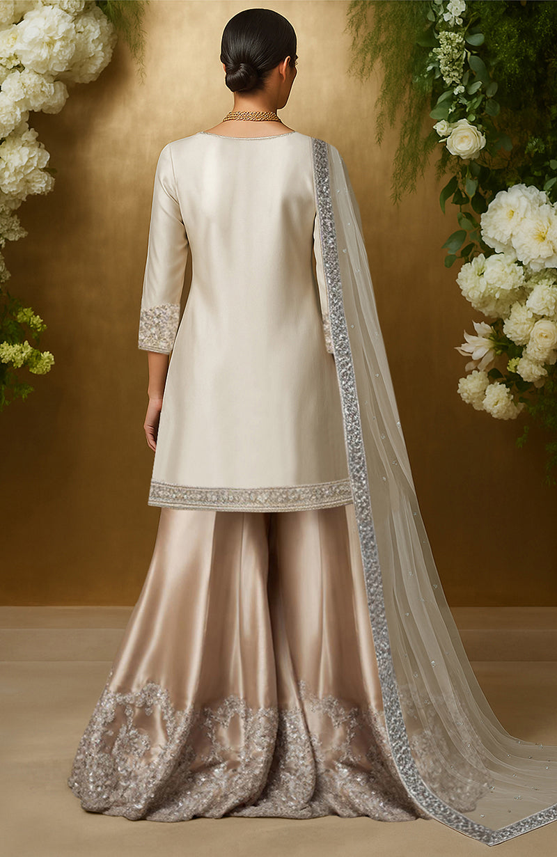 Ivory sharara set with silver bead and crystal embroidery on kurta, flared pants, and dupatta.