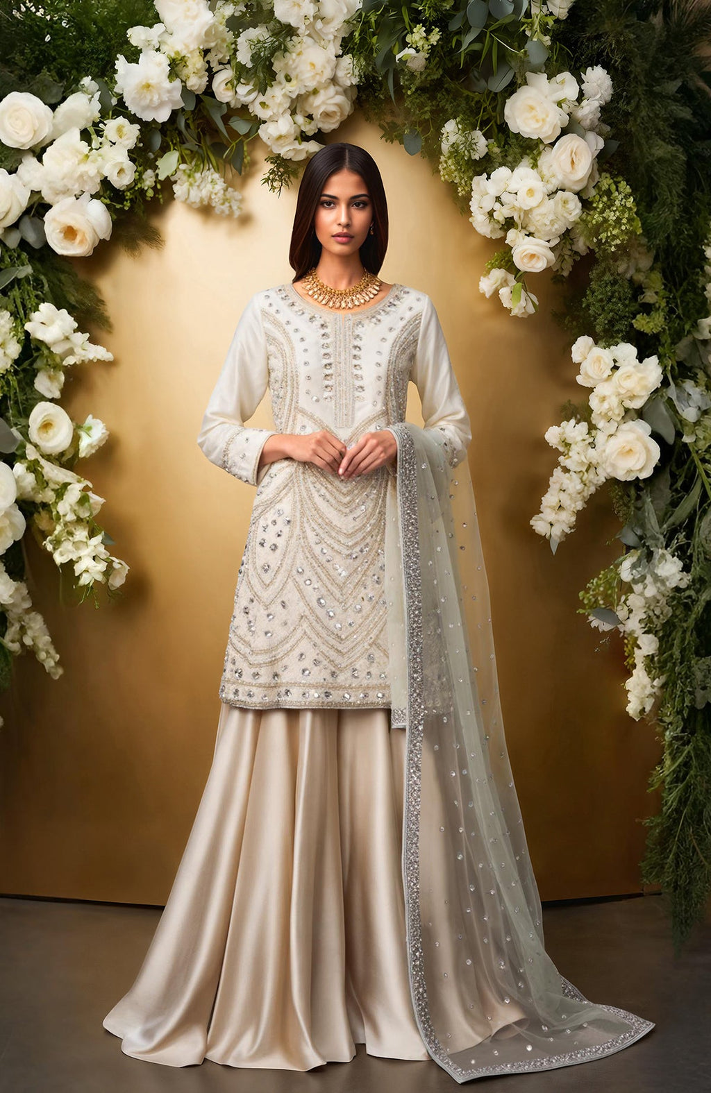 Ivory sharara set with bead, crystal embroidery, silver embellishments, and sheer dupatta.