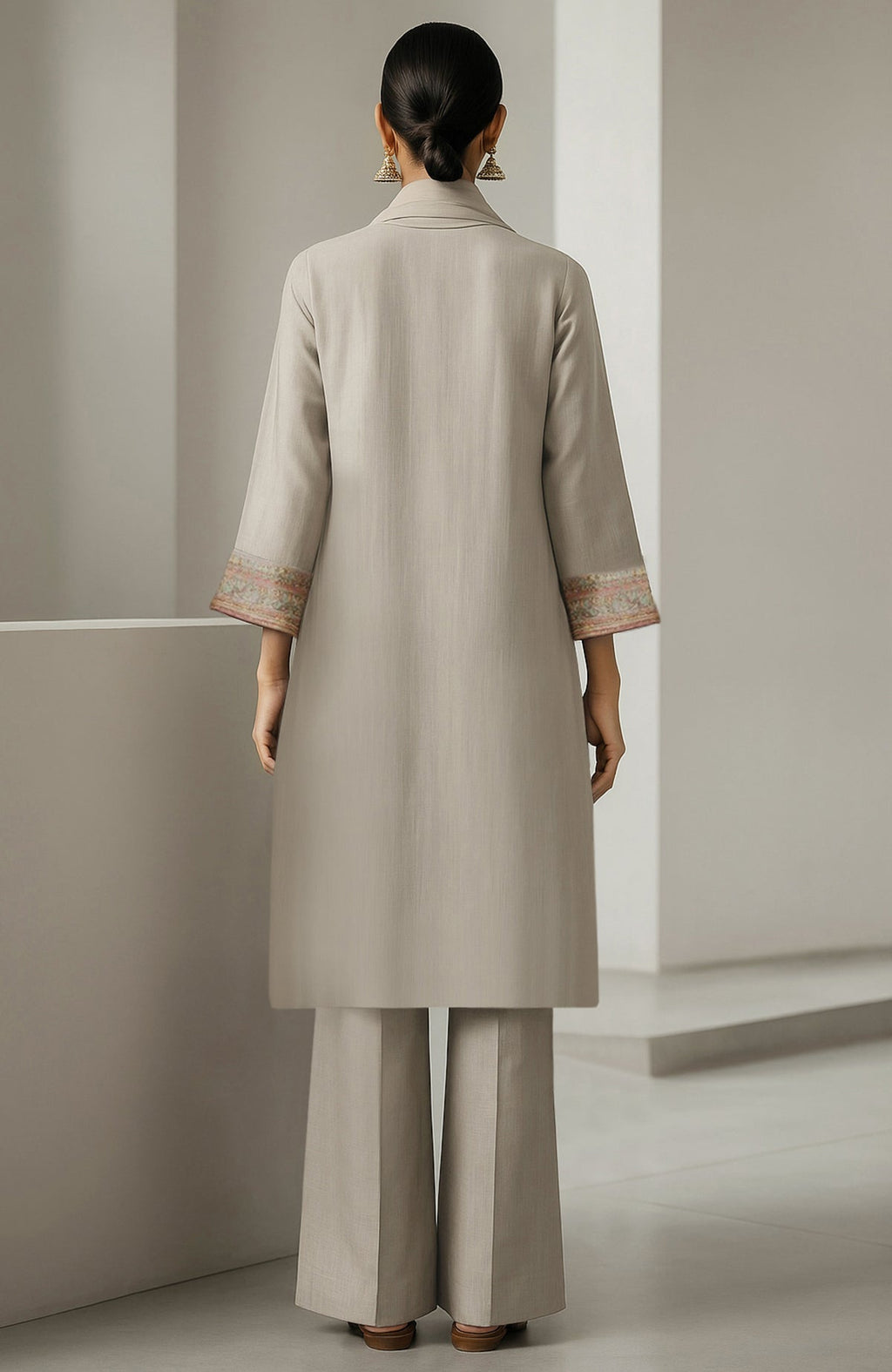 Ivory straight-cut kurta with embroidery, wide-leg trousers, and sheer organza dupatta with floral motifs.
