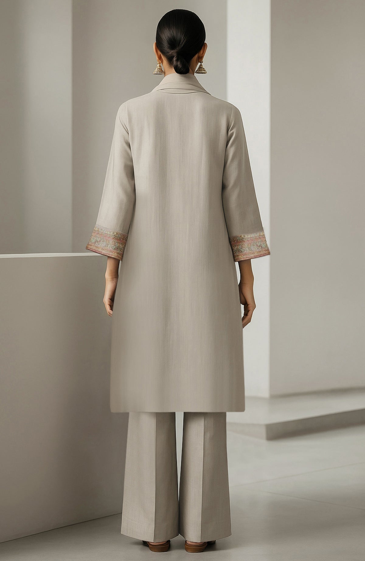 Ivory straight-cut kurta with embroidery, wide-leg trousers, and sheer organza dupatta with floral motifs.