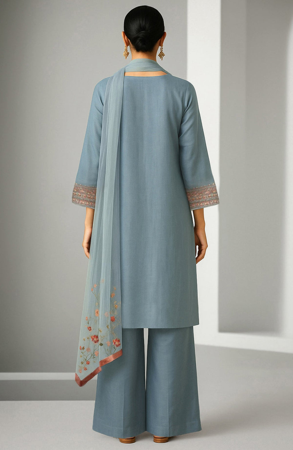 Powdered indigo kurta with embroidery, wide-leg trousers, and sheer organza dupatta with floral border.