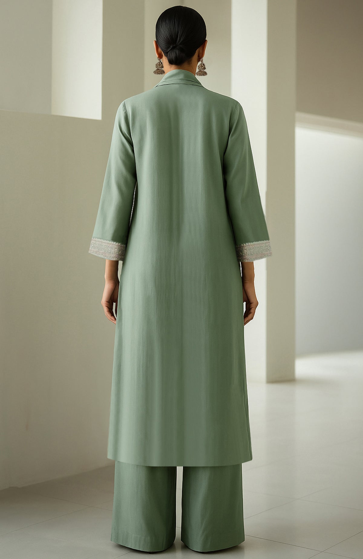 Eucalyptus green straight kurta with embroidery, wide-leg trousers, and sheer organza dupatta.