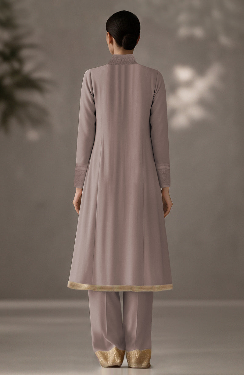 Taupe long kurta with floral embroidery, pleated drape detail, and matching tapered trousers.