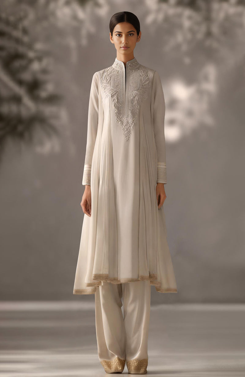Powder blue kurta with floral embroidery, pleated drape design, and matching loose trousers.