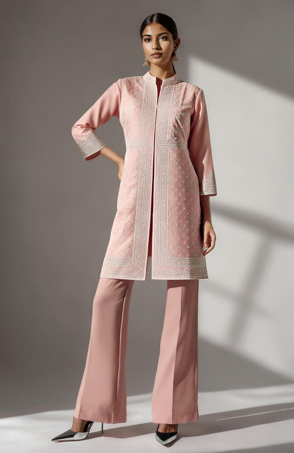 Blush pink straight kurta with ivory chikankari embroidery paired with flared palazzo pants.