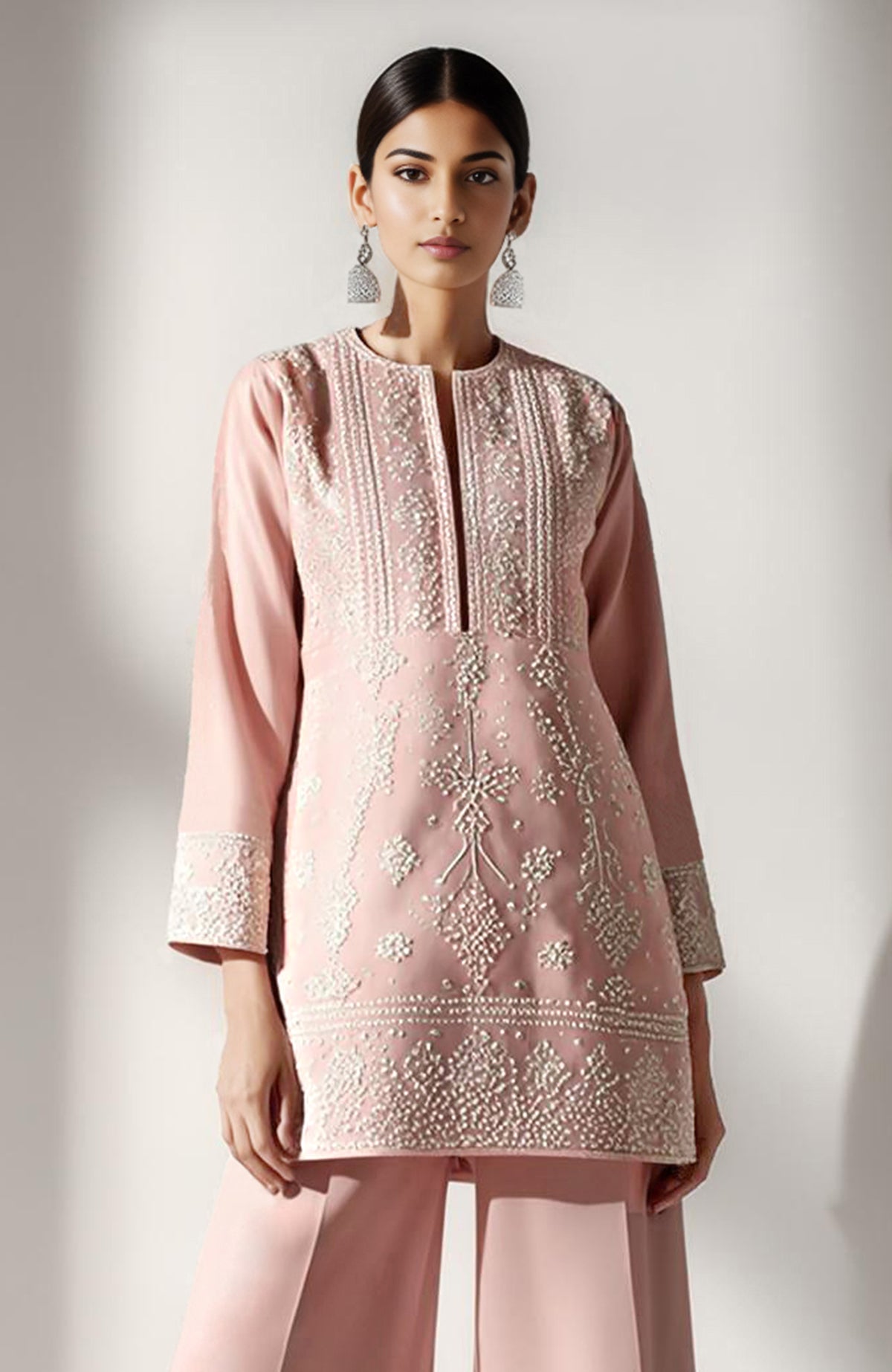 Blush pink short kurta with ivory floral embroidery paired with wide palazzo pants.