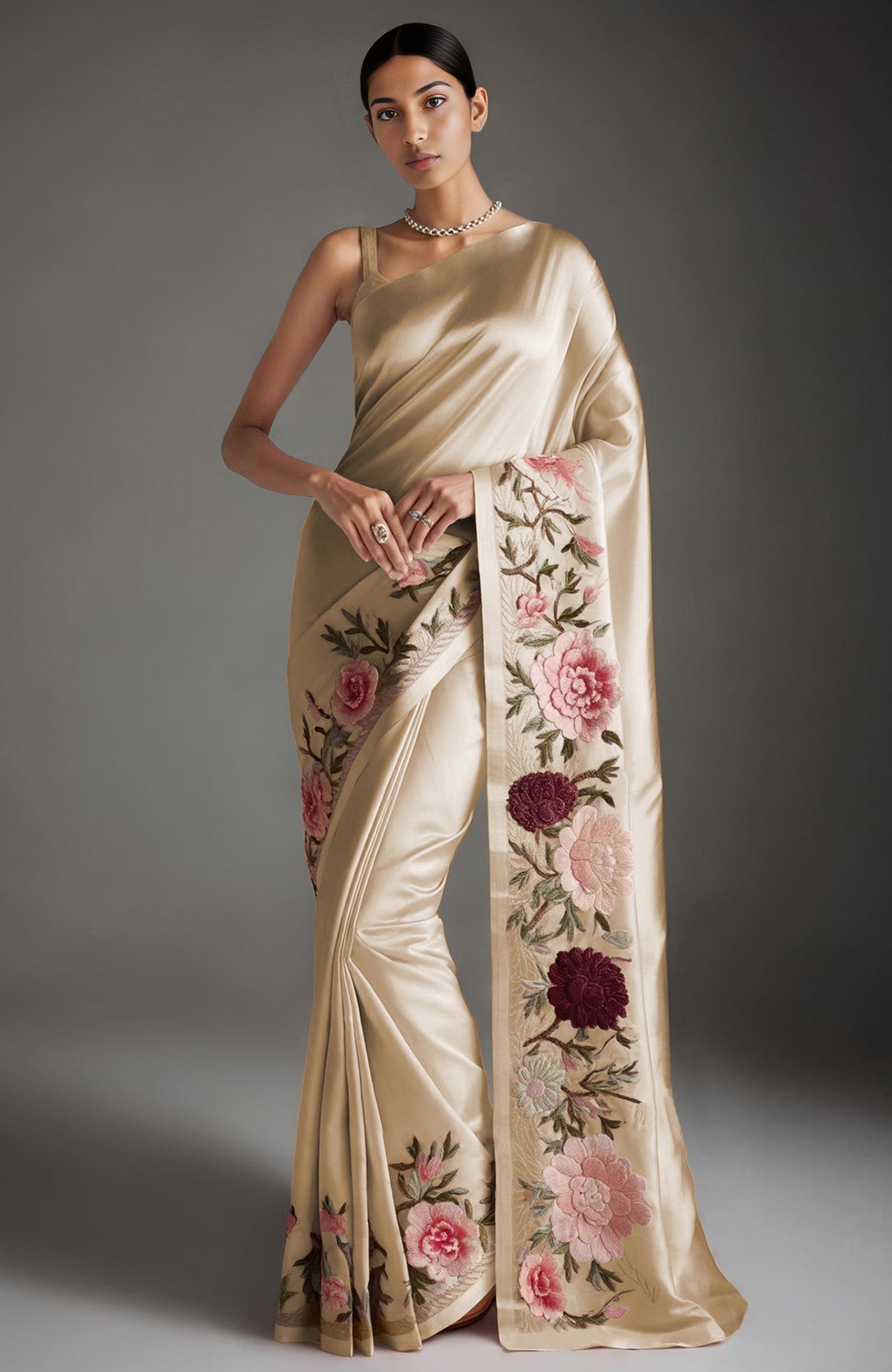 Blush pink saree with embroidered peonies and roses and a sleeveless blouse with gold straps