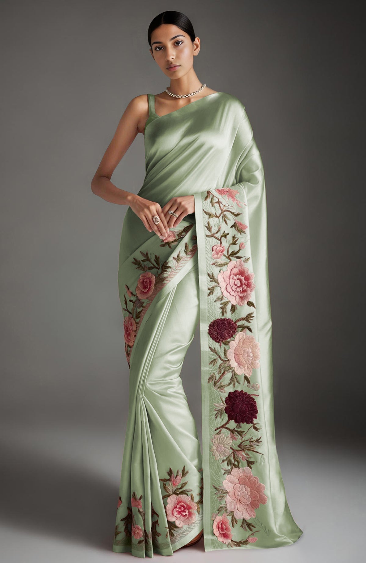 Blush pink saree with embroidered peonies and roses in silk threads and a sleeveless blouse.