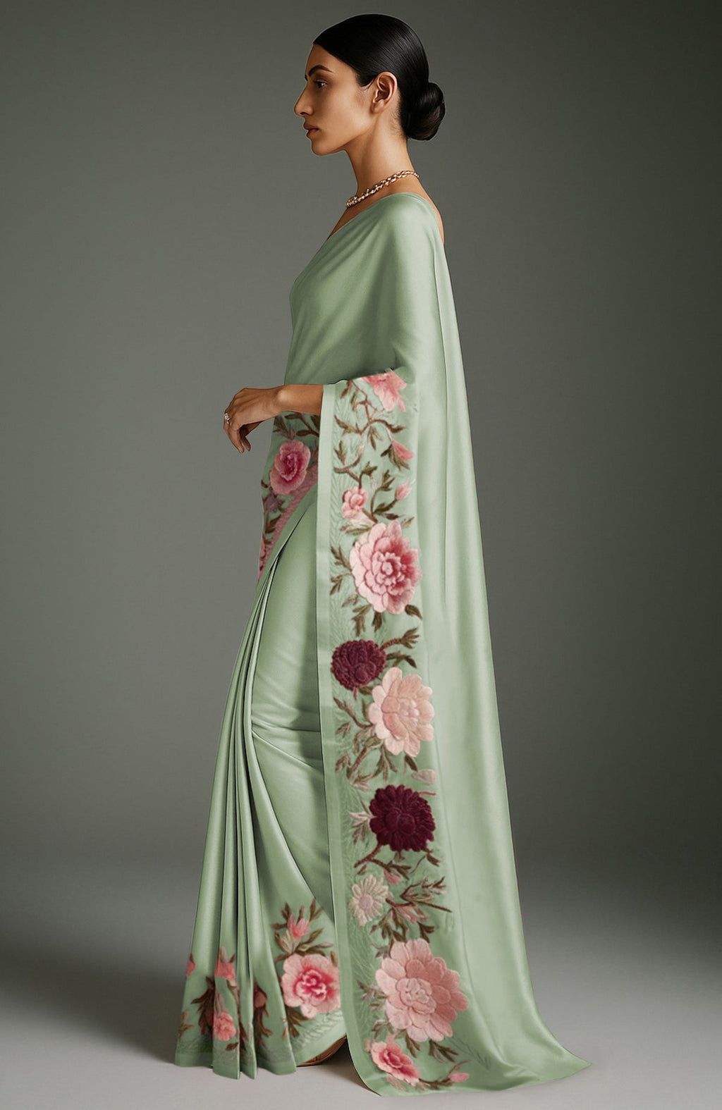 Sage green saree with embroidered peonies and roses in pink, burgundy, ivory, and green colors.