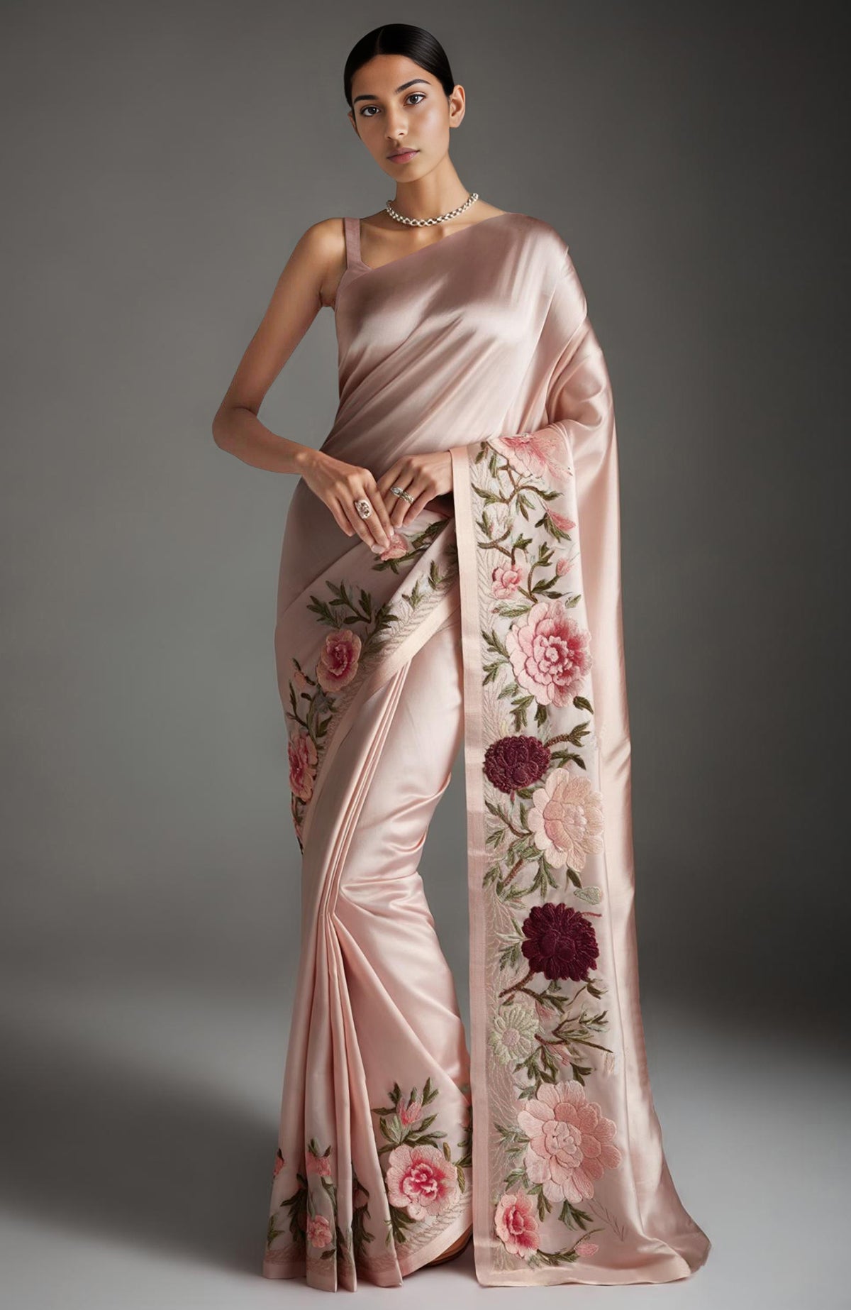 Sage green saree with embroidered peonies and roses in pink, burgundy, ivory, and green tones.