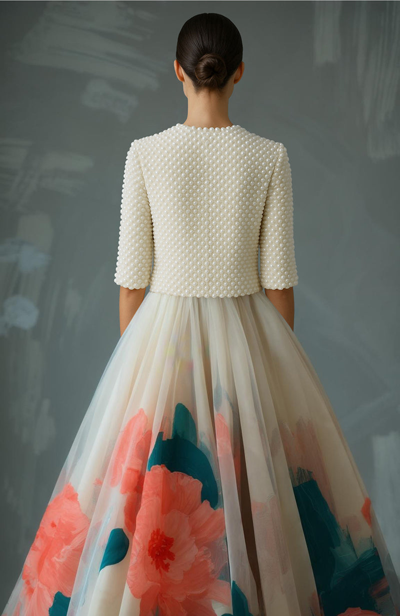 Cropped pearl-embroidered jacket with round neck and floral high-waisted full-length skirt.