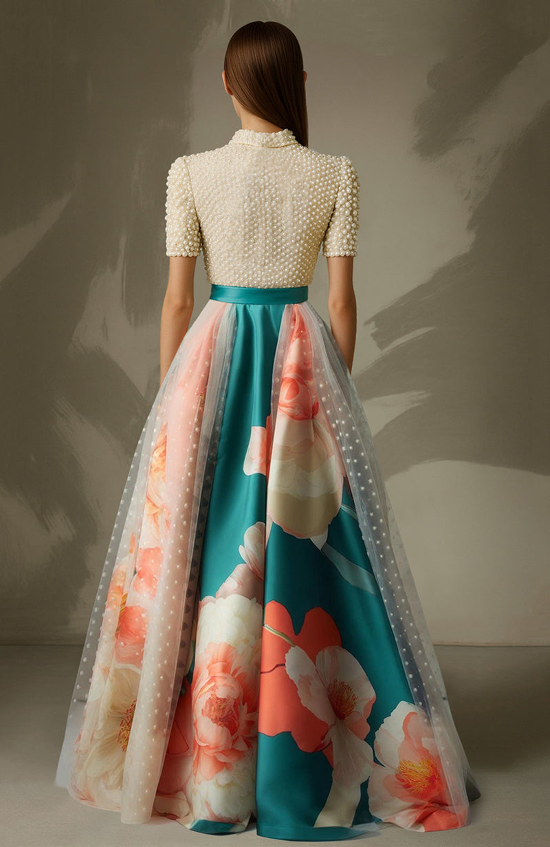Teal A-line skirt with floral print and sheer overlay paired with pearl-embroidered blouse with bow.