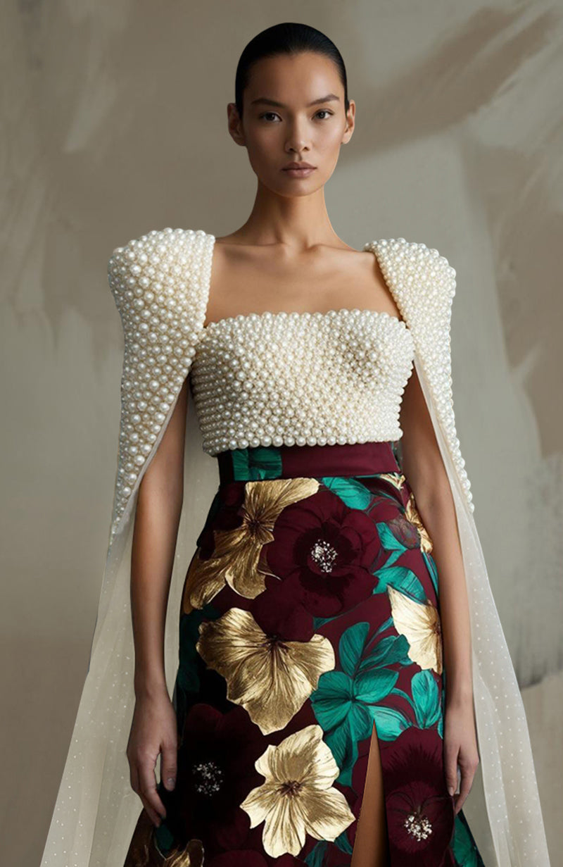 Black skirt and bustier set with pearl embroidery and large colorful floral prints.