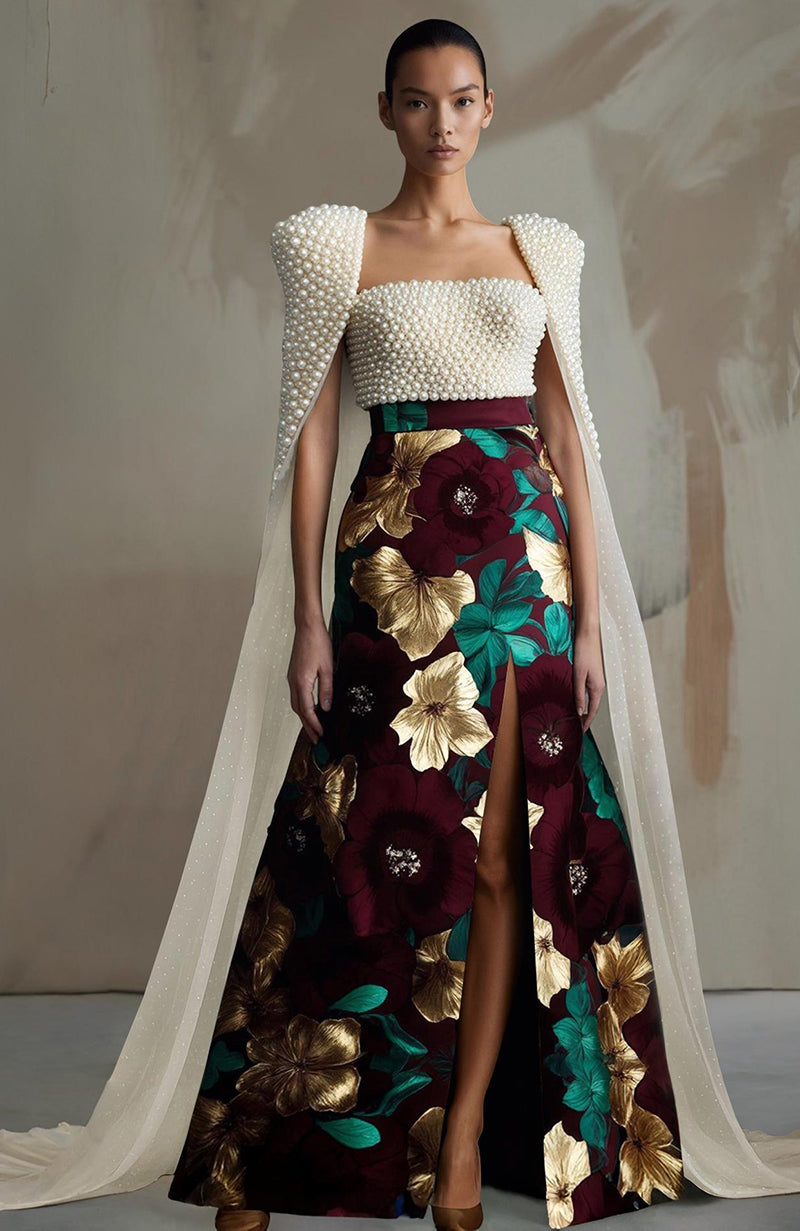 Black bustier with ivory pearl embroidery and sheer panels paired with a floral high-slit skirt.