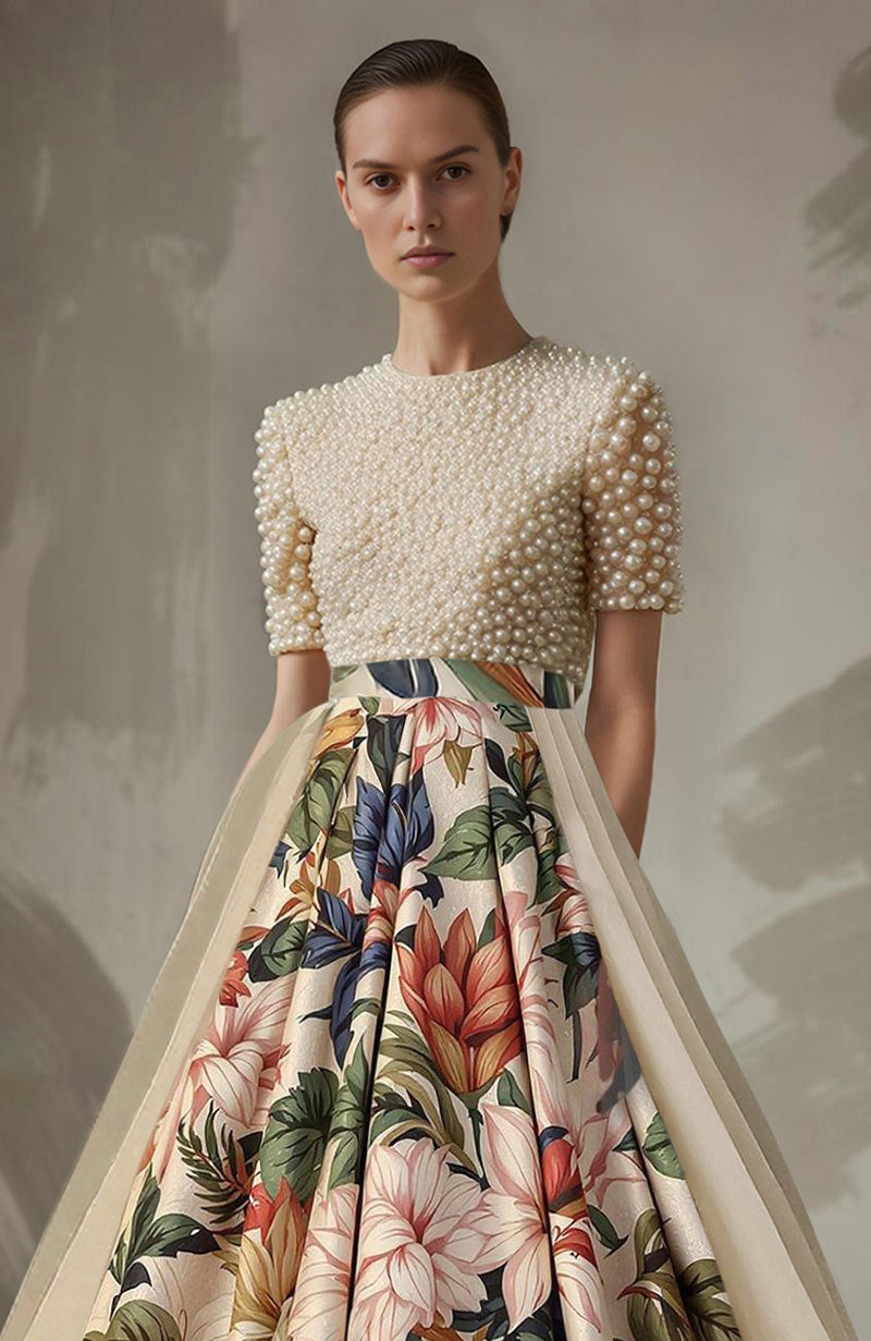 Ivory pearl-embroidered short-sleeve top paired with a floral A-line skirt with sheer panels.
