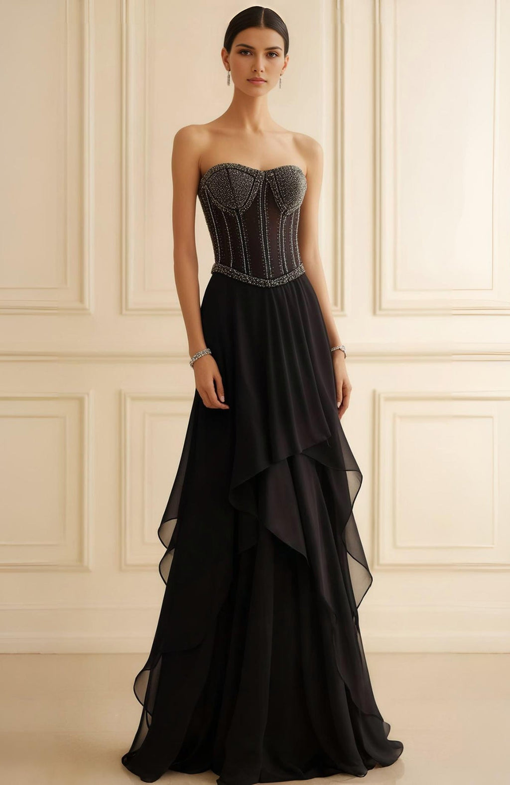 Strapless black evening gown with beaded corset bodice and layered flowing chiffon skirt.