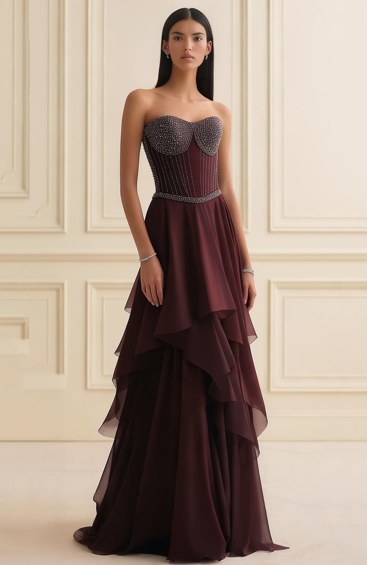 Strapless garnet corset gown with beaded sweetheart bodice and layered asymmetric georgette skirt.