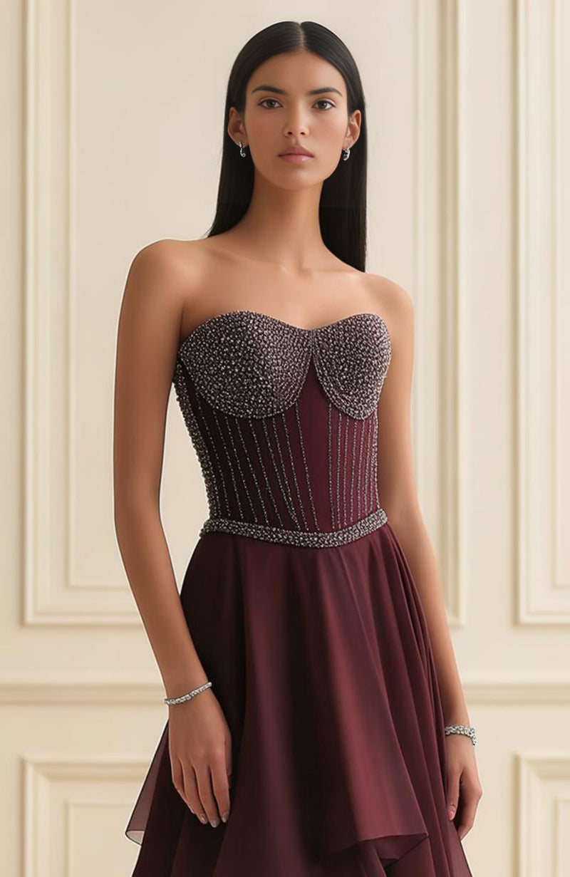 Strapless garnet corset gown with beaded sweetheart bodice and layered asymmetric georgette skirt