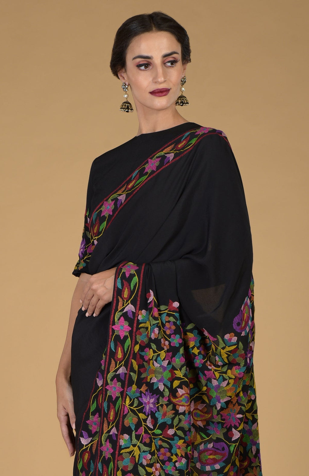 Black pure crepe silk saree with colorful Kani art floral and paisley embroidery.