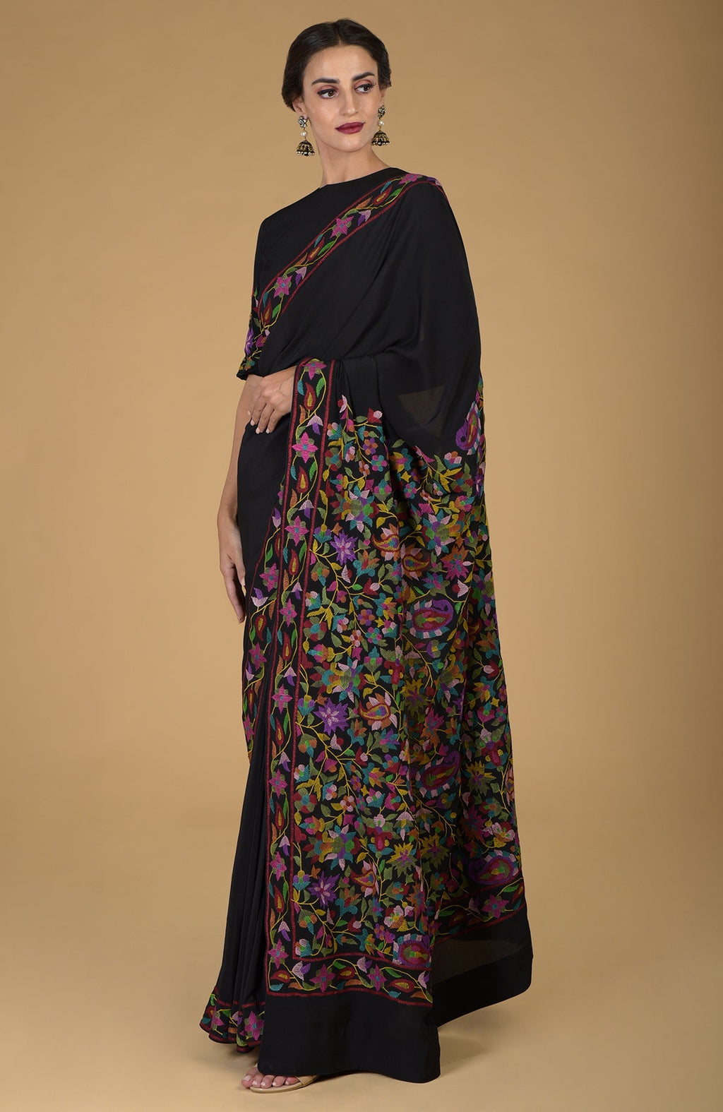Black pure crepe silk saree with colorful Kani art floral embroidery.