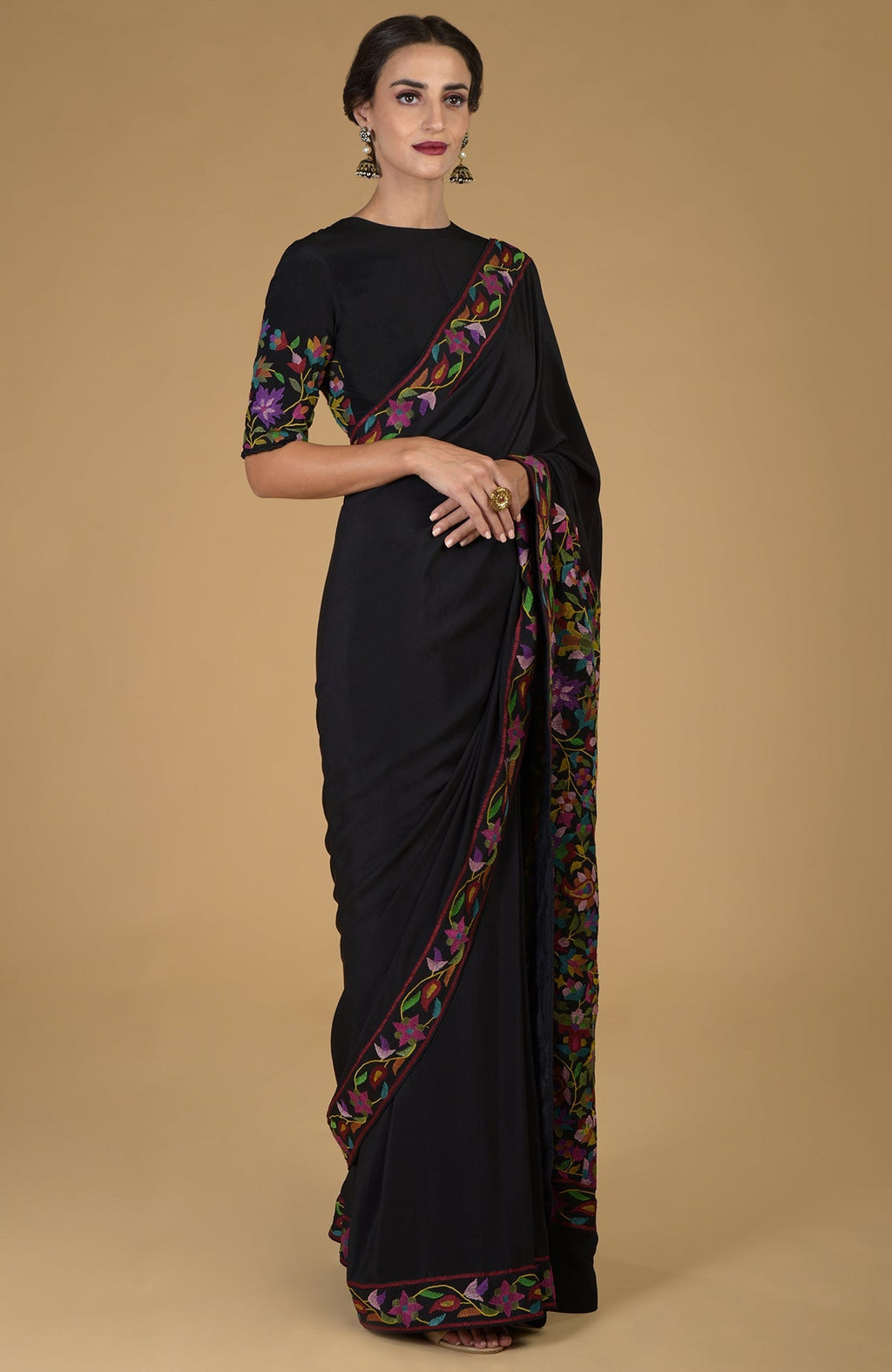 Black pure crepe silk saree with colorful Kani art embroidery on the borders and pallav.