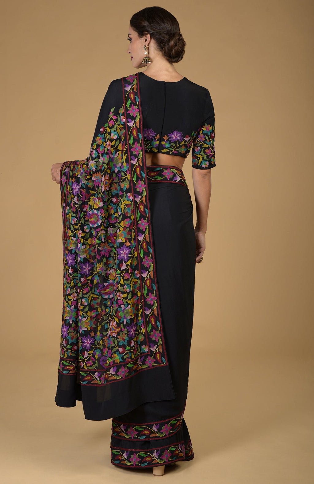 Black pure crepe silk saree with multi-color Kani art floral embroidery.