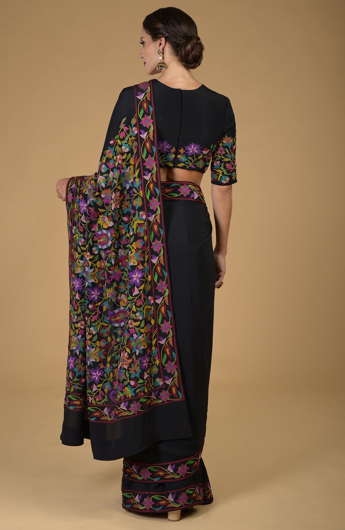 Black pure crepe silk saree with multi-color Kani art floral embroidery.