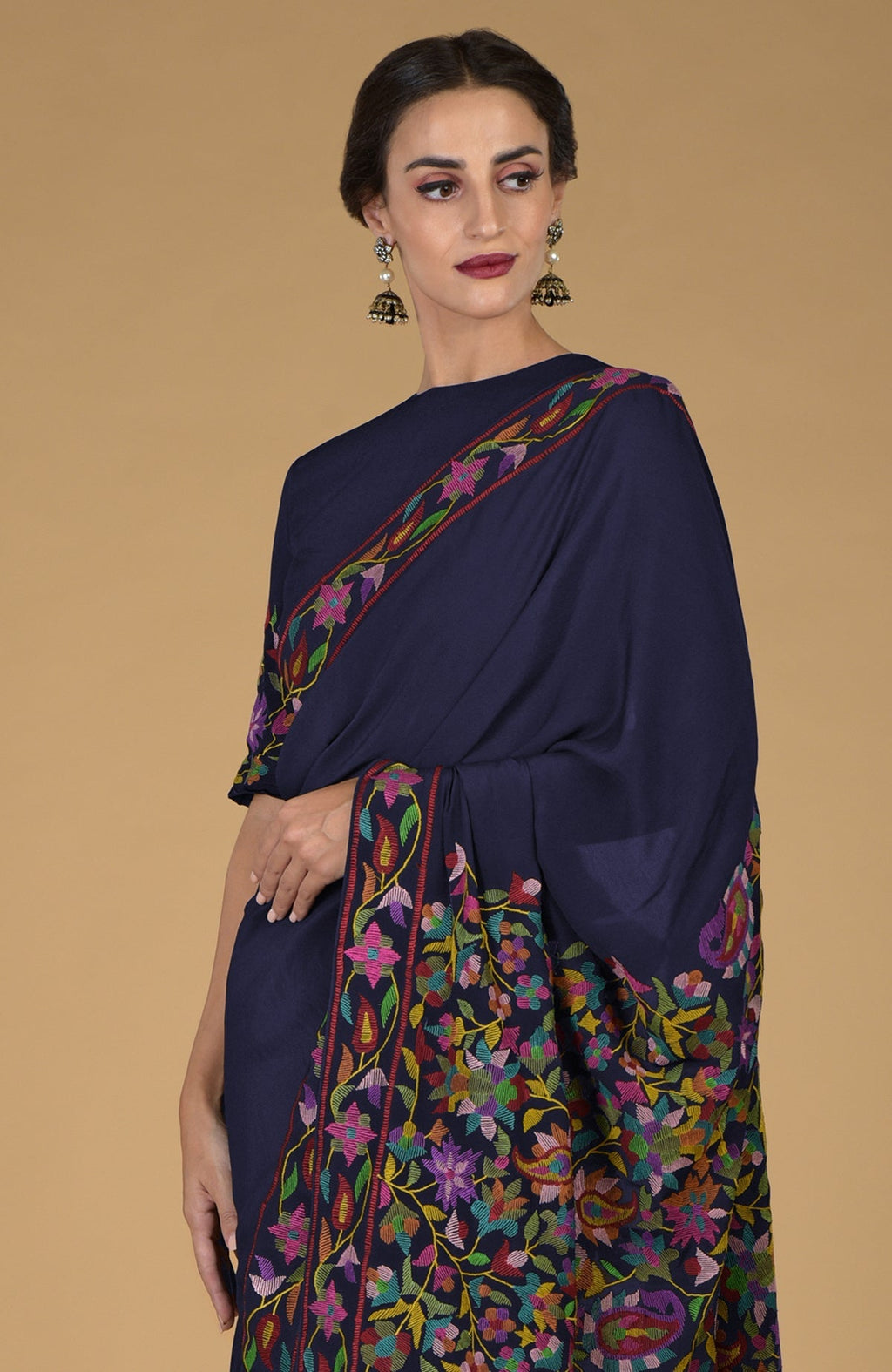 Midnight blue pure crepe silk saree with multicolor Kani art floral embroidery.