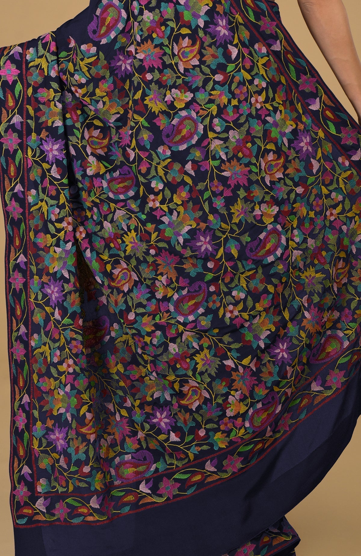 Midnight blue pure crepe silk saree with colorful Kani art floral and paisley embroidery.