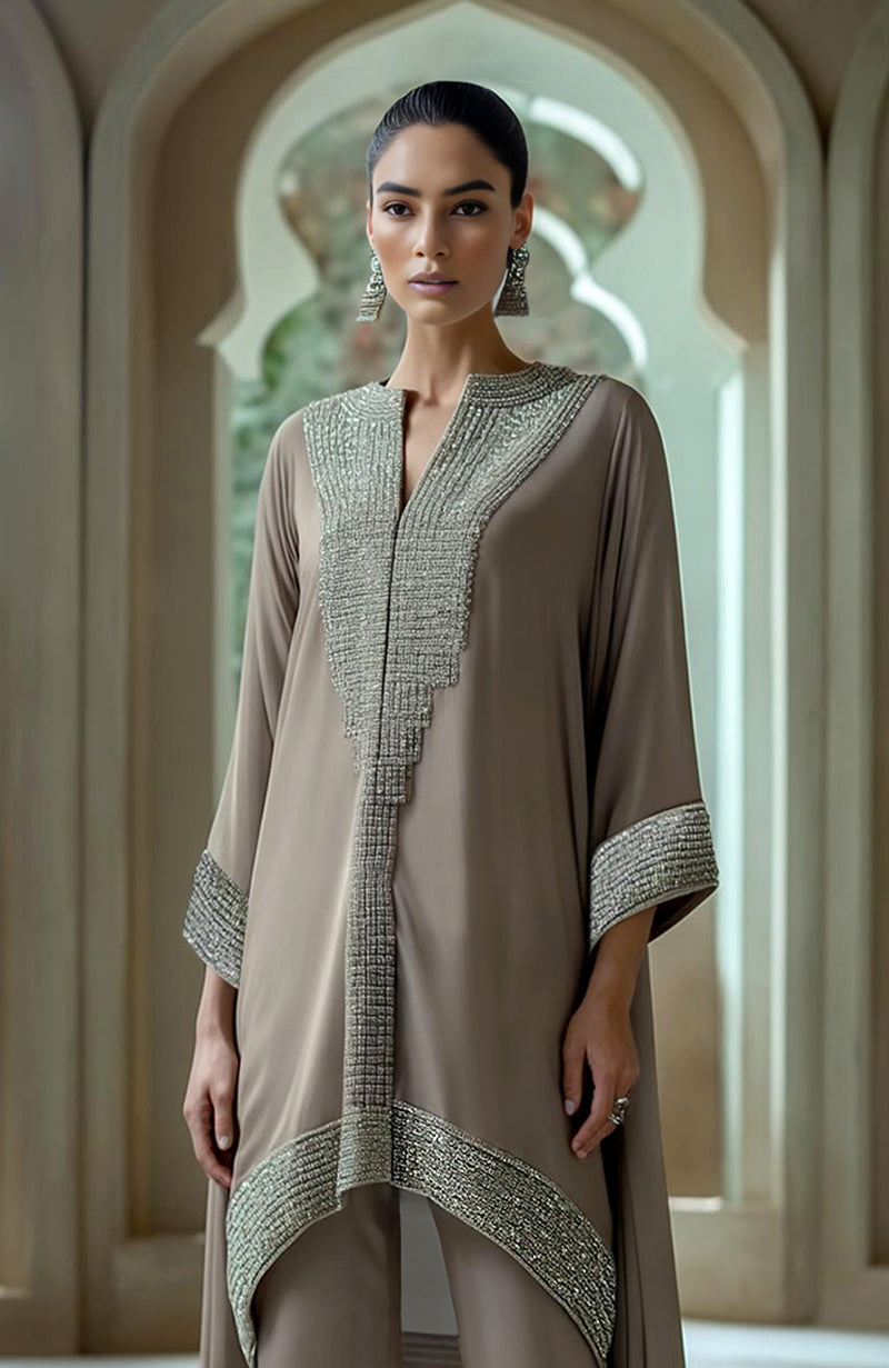 Taupe asymmetric kurta set with dense bead and crystal embroidery on neckline and cuffs.