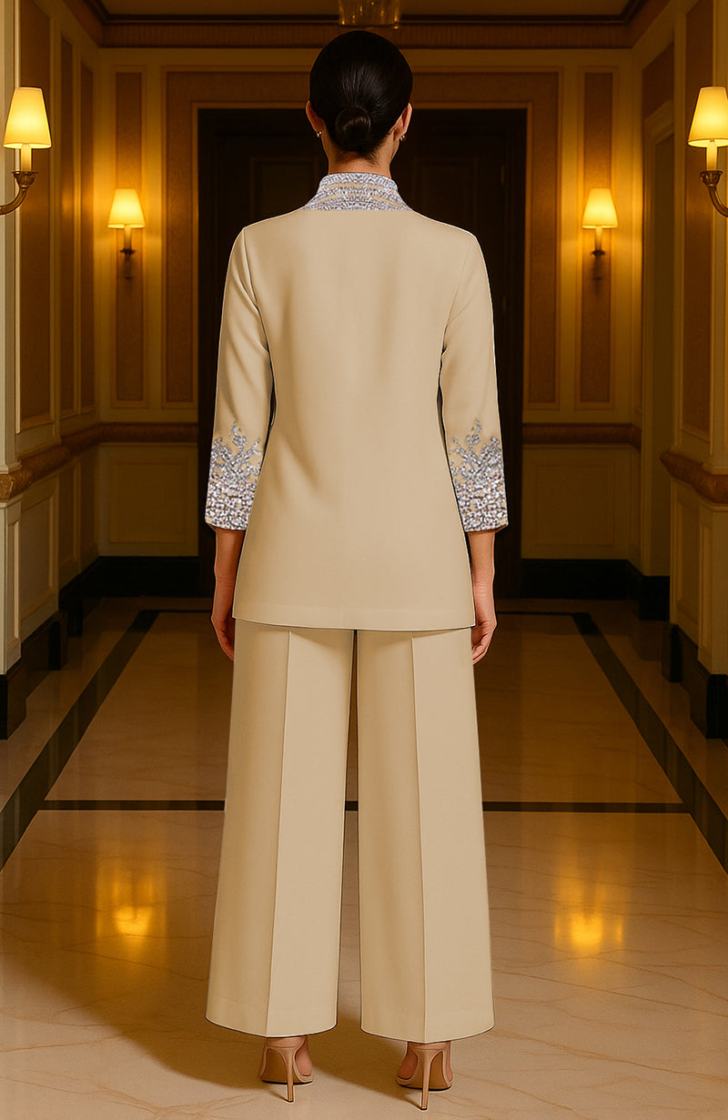 Champagne Royale two-piece with crystal embroidery, silver and gold accents, and sapphire blue stones