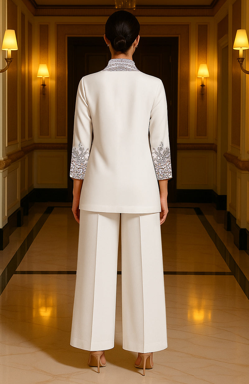 Ivory two-piece ensemble with crystal embroidery, silver and gold accents, and sapphire blue stones.