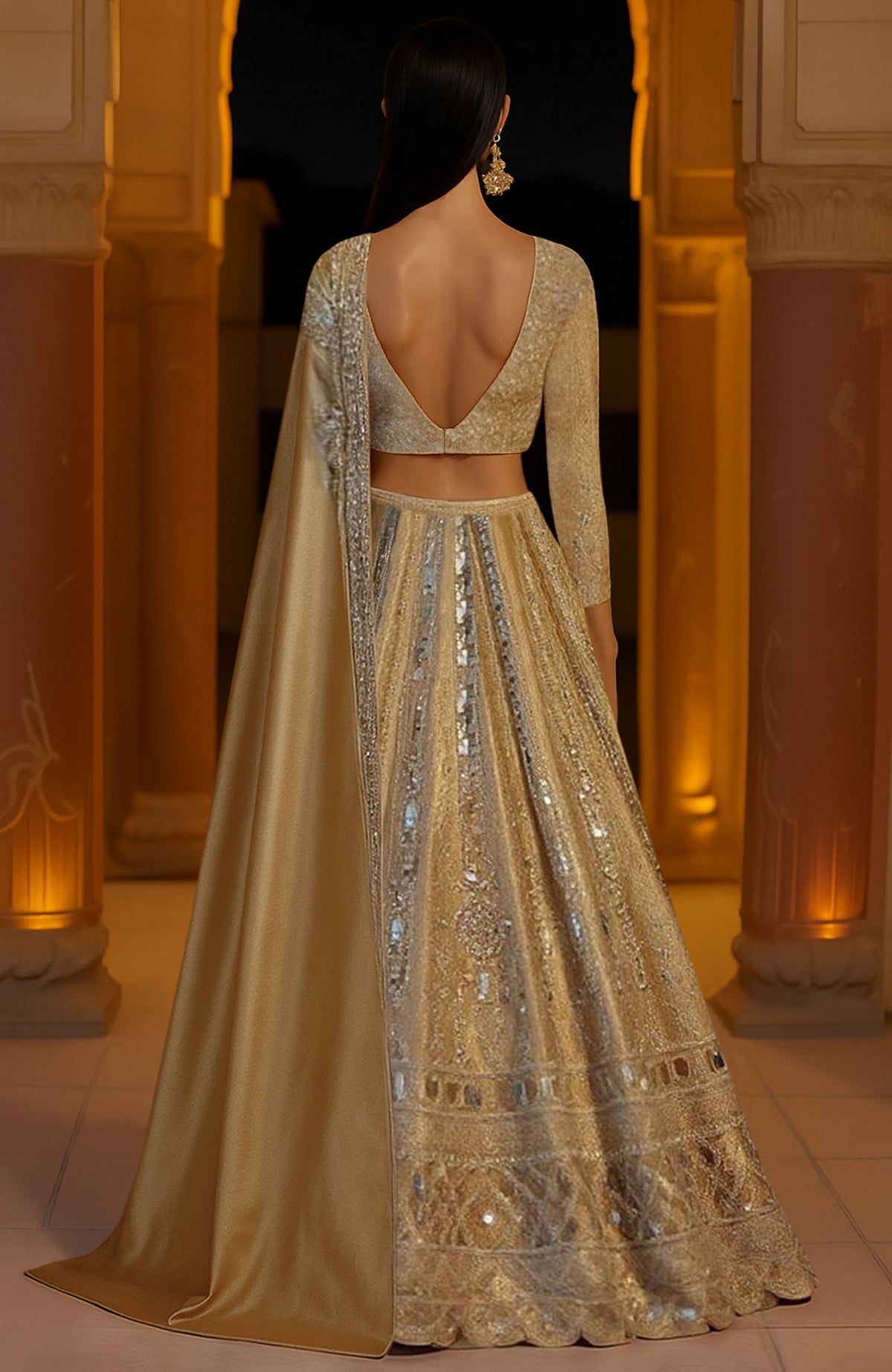 Gold lehenga set with mirror embroidery, V-neck corset blouse, and floor-length satin cape