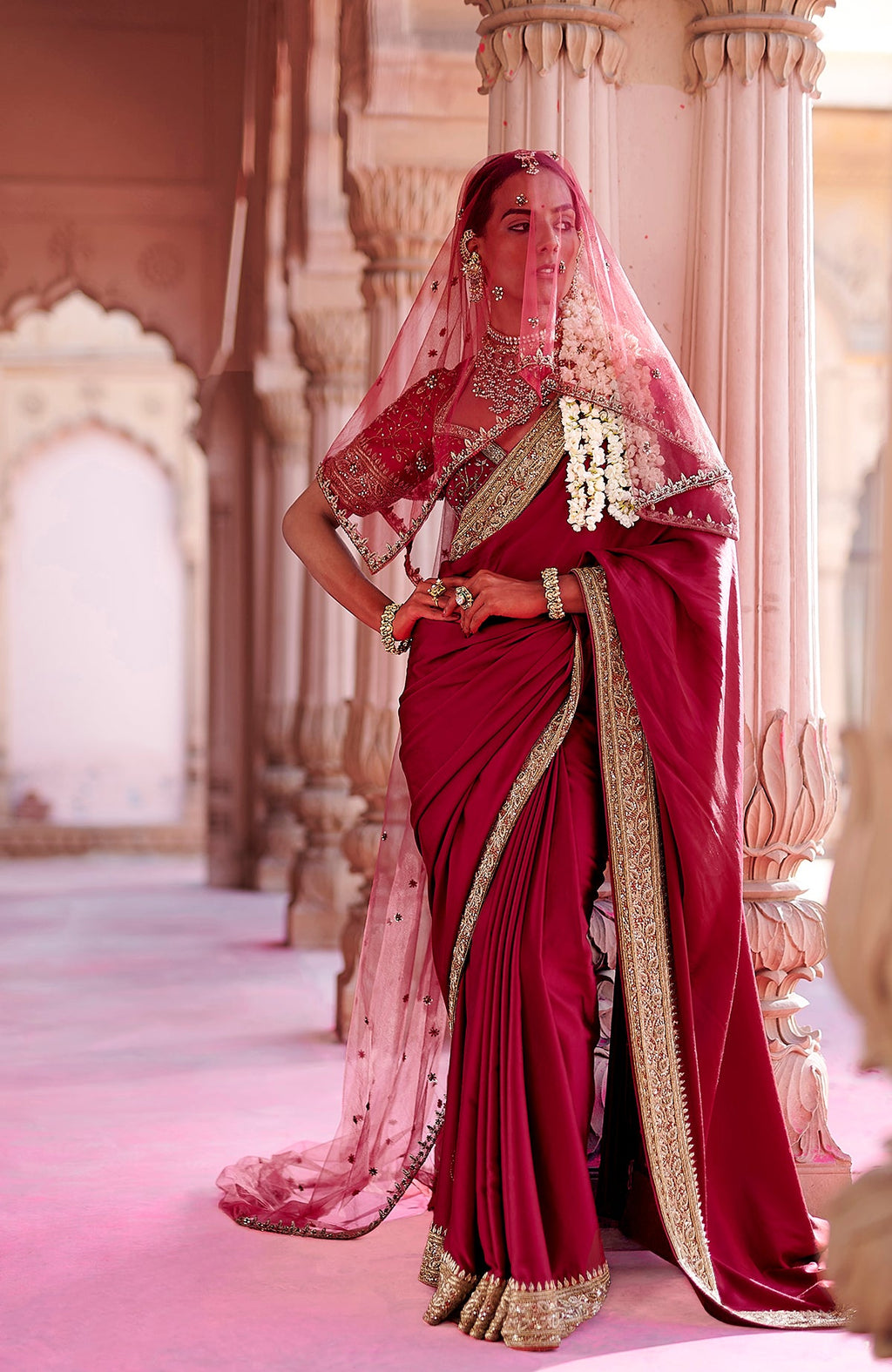 Blood red pure silk saree with gold zardozi embroidery and embellished blouse with net dupatta