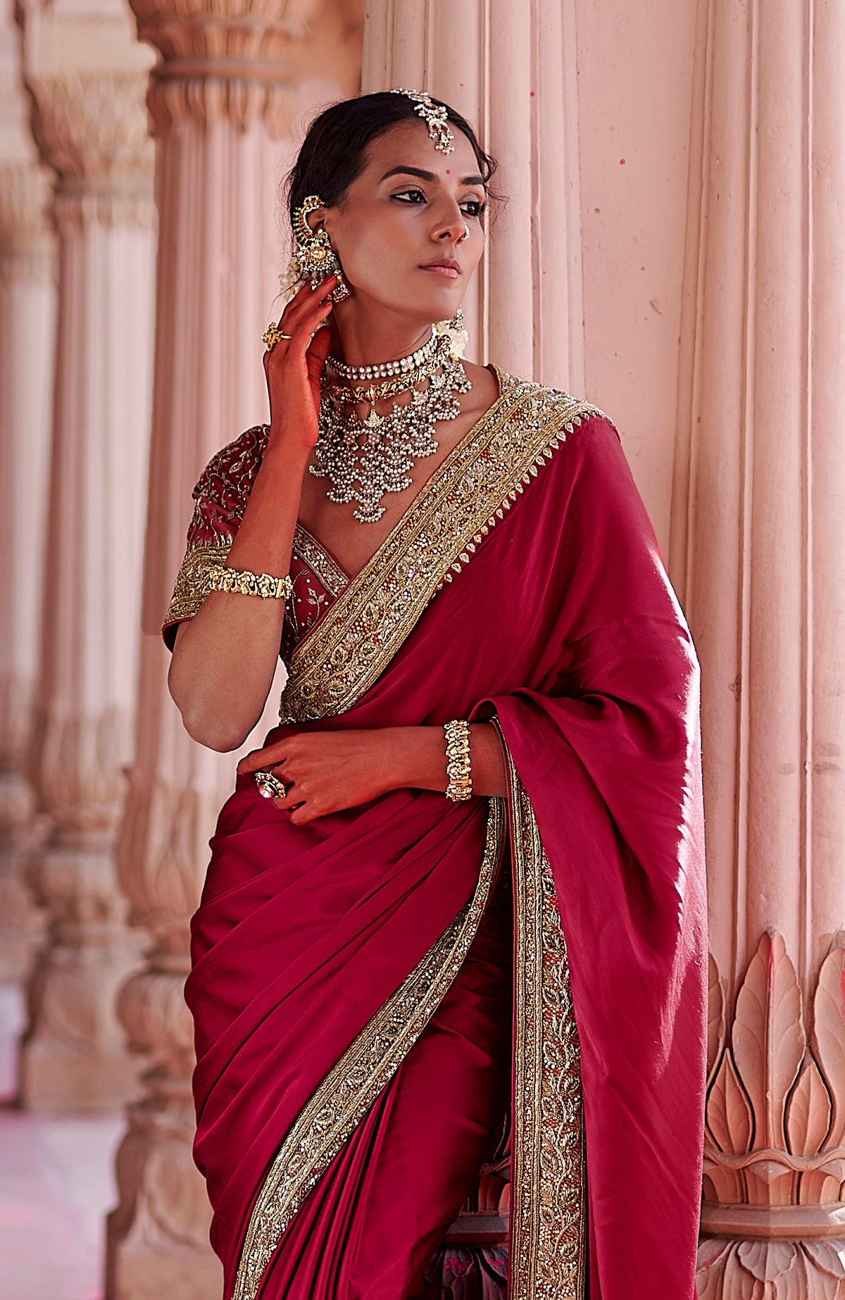 Blood red pure silk saree with gold zardozi floral embroidery and embellished blouse details