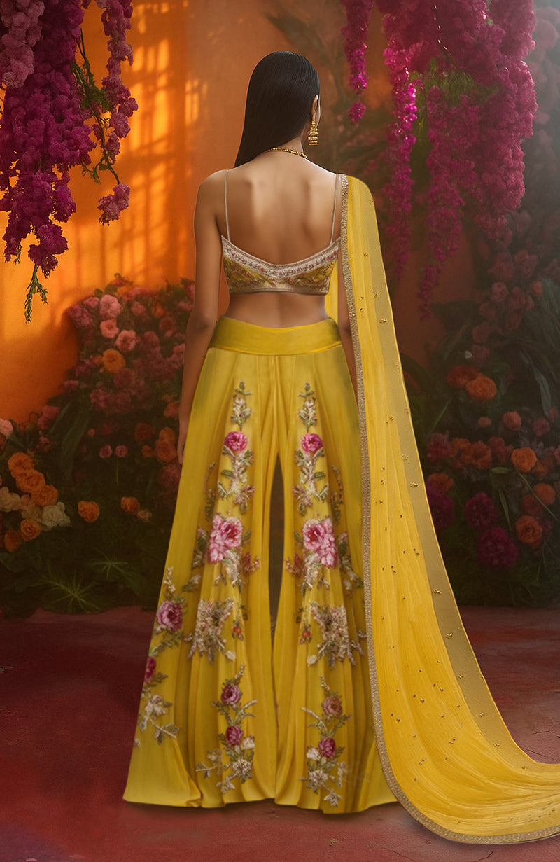 Golden sharara set with pink and ivory floral embroidery and a matching embroidered bralette blouse.