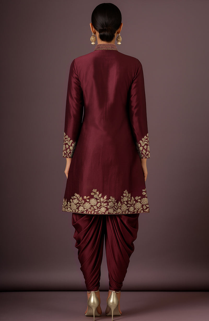 Merlot silk sherwani jacket with gold floral embroidery and matching ruched dhoti trousers.