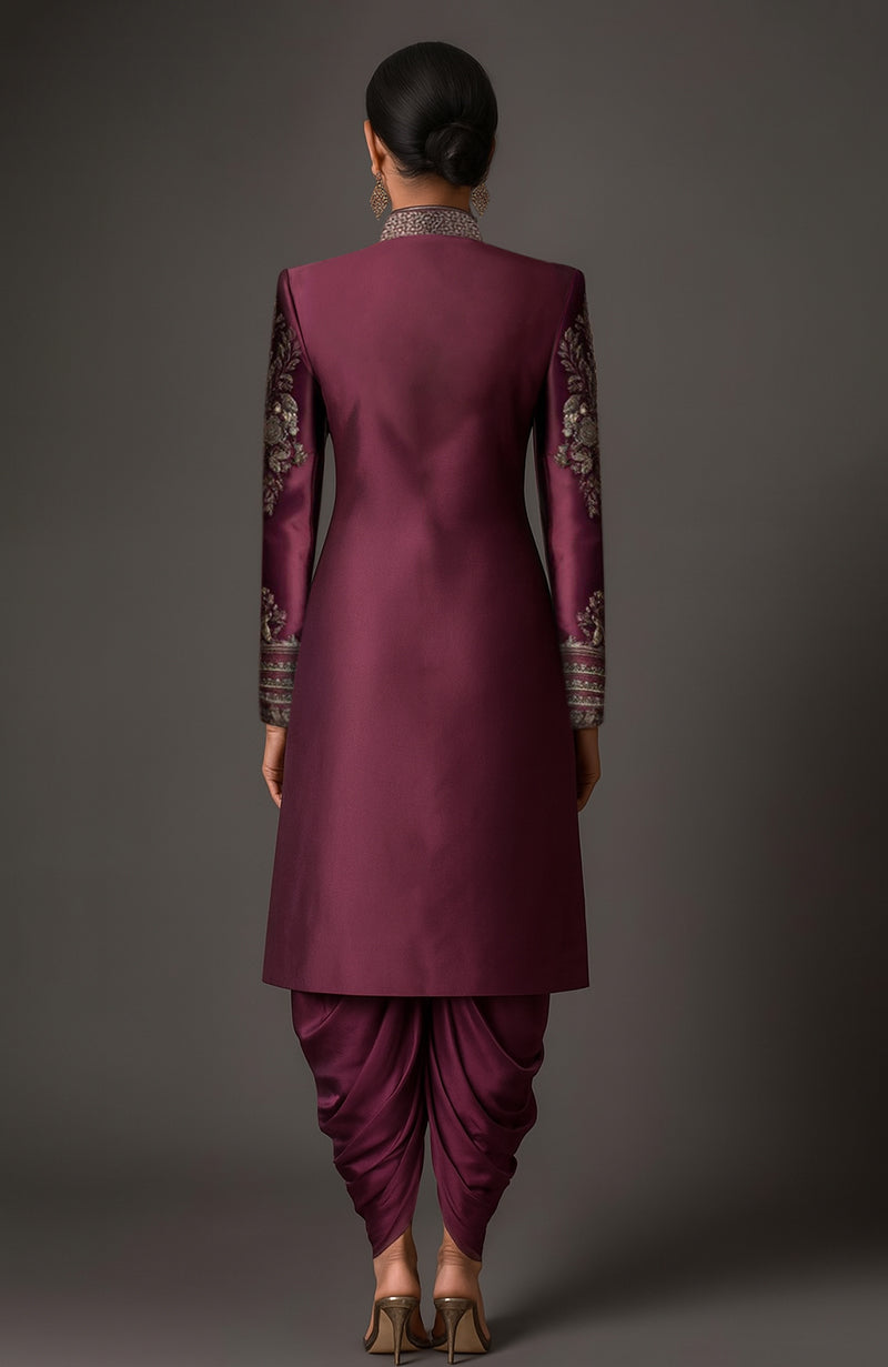 Deep plum satin sherwani jacket with gold floral embroidery and matching pleated dhoti trousers.
