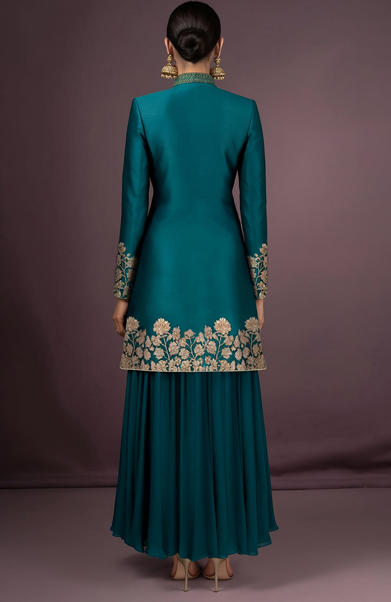 Teal silk jacket with gold floral embroidery and matching asymmetrical georgette skirt.