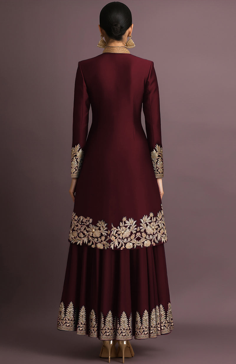Maroon embroidered jacket set with high collar and gold-toned buttons, paired with flared skirt.