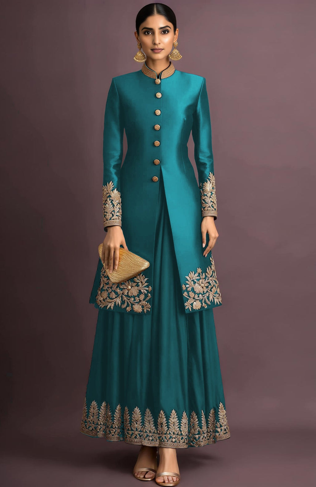 A woman models a teal embroidered jacket set with a matching skirt and gold clutch.