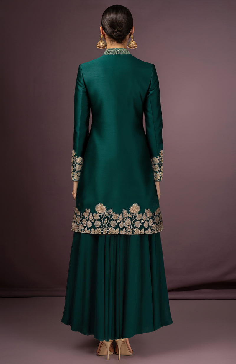 Emerald green silk jacket and skirt set with gold embroidery and high collar detailing.