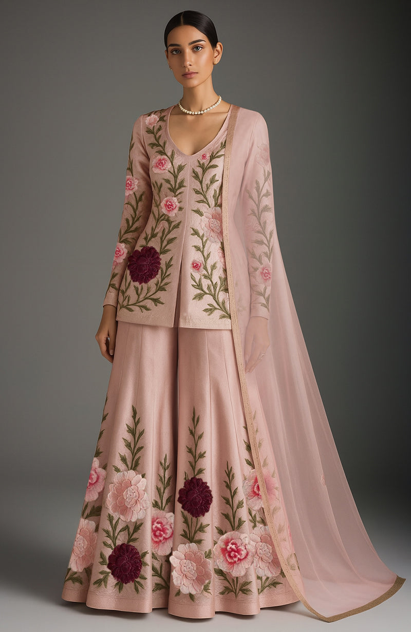 Blush pink sharara set with floral embroidery, fitted kurta, flared pants, and sheer dupatta.