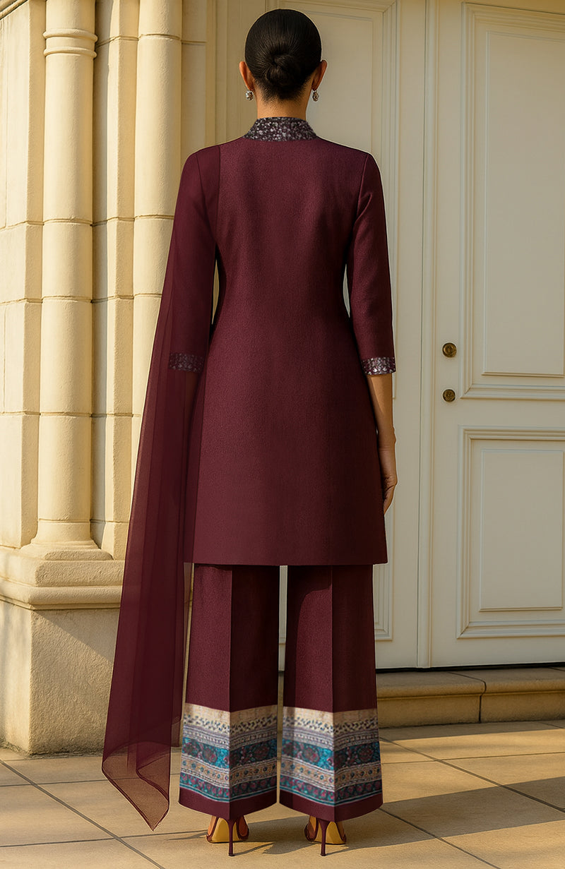 Deep wine three-piece set with embellished slit jacket, wide-leg pants, and sheer dupatta.