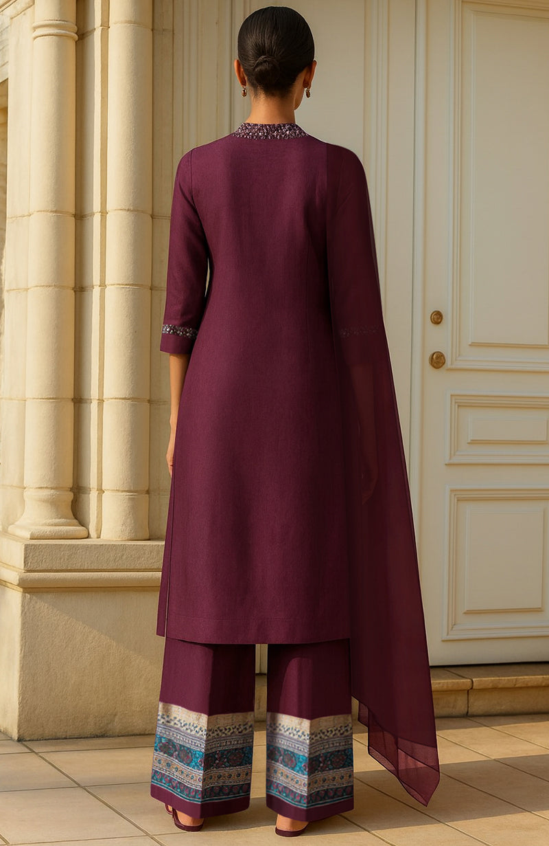 Deep wine kurta set with silver mirror embellishments and teal printed borders, sheer matching dupatta.