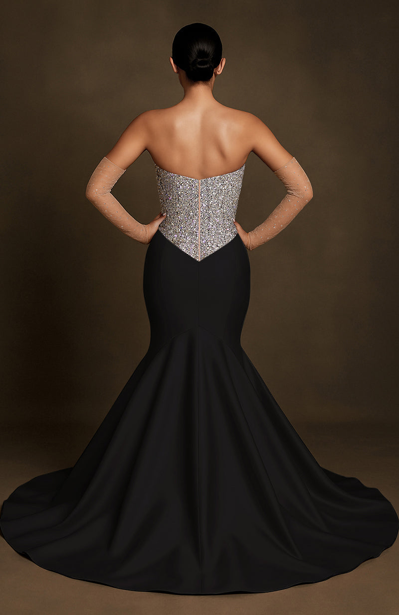 Strapless black mermaid gown with silver crystal-encrusted bodice and flared floor-length skirt.