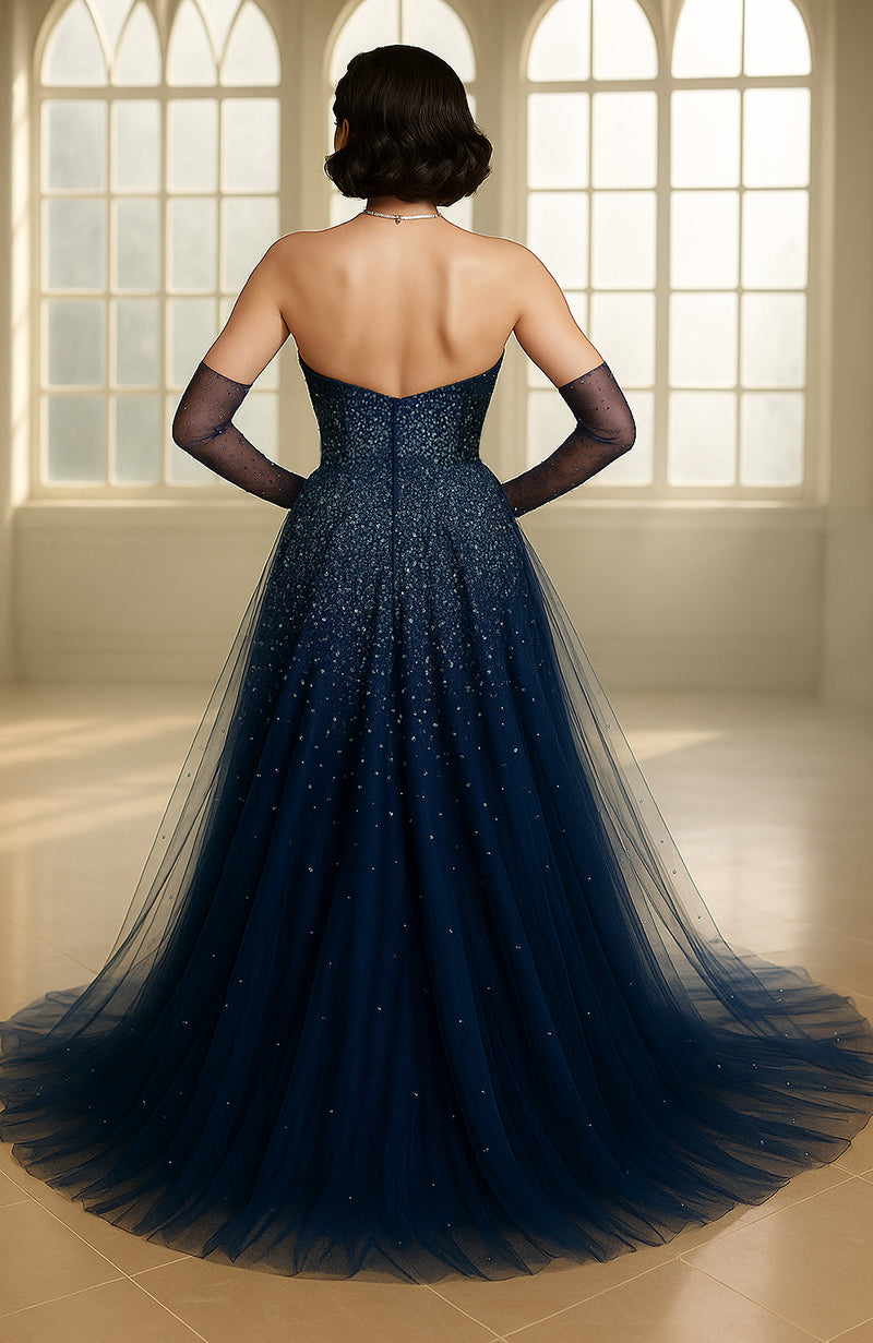 Deep navy strapless gown with embroidered bodice and layered tulle skirt resembling a starry night.