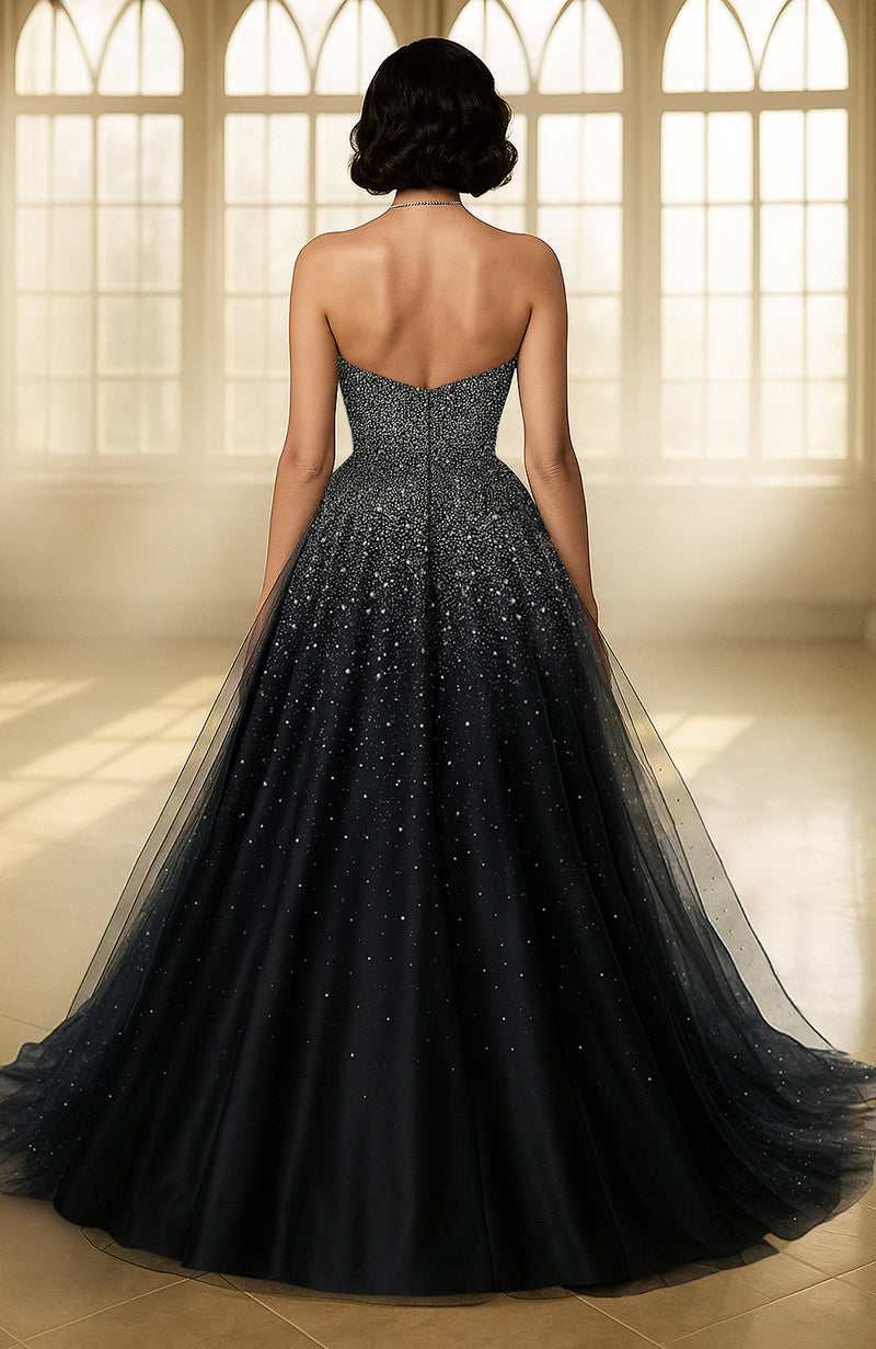 Black strapless gown with embroidered bodice and layered tulle skirt featuring star-like embellishments